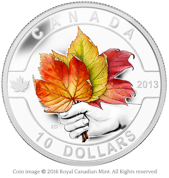 coin maple leaves in hand